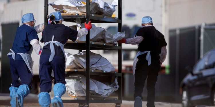 File photo: el paso county medical examiner's office staff move bodies in el paso