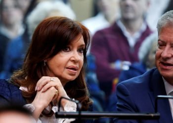 Former argentine president cristina fernandez de kirchner speaks to her lawyer, carlos beraldi, in a court room before the start of a corruption trial, in buenos aires